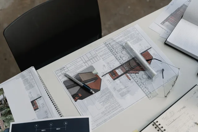 Top view of architectural blueprints and drafting tools on a workspace desk. How to test table extraction on different document layouts